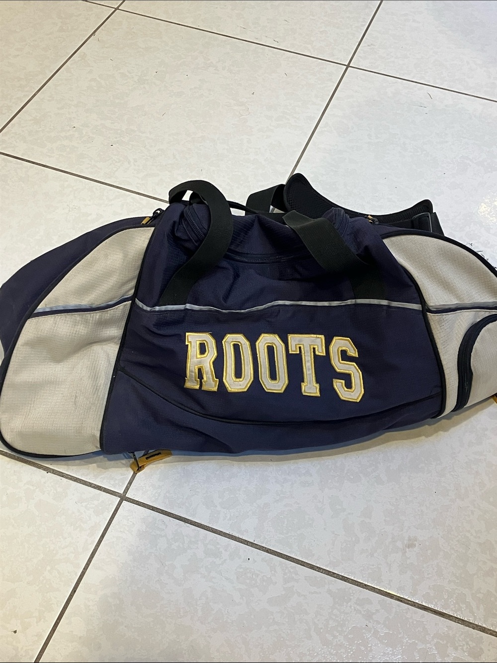 Roots Navy and Cream Duffel with Gold Logo